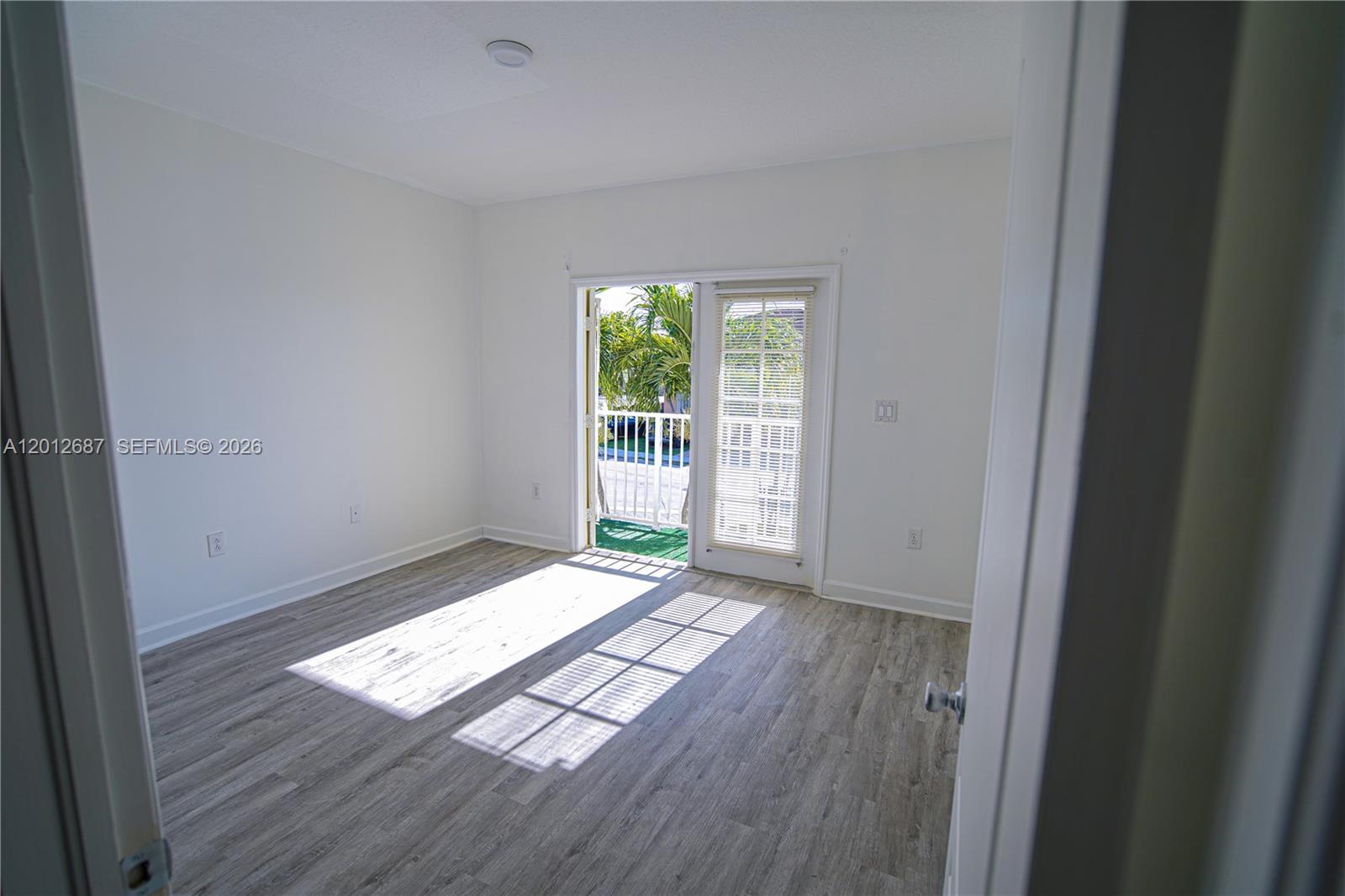1751 Southwest 154th Path Miami, FL 33185 - Photo 35 of 41 an empty room with wooden floor and windows