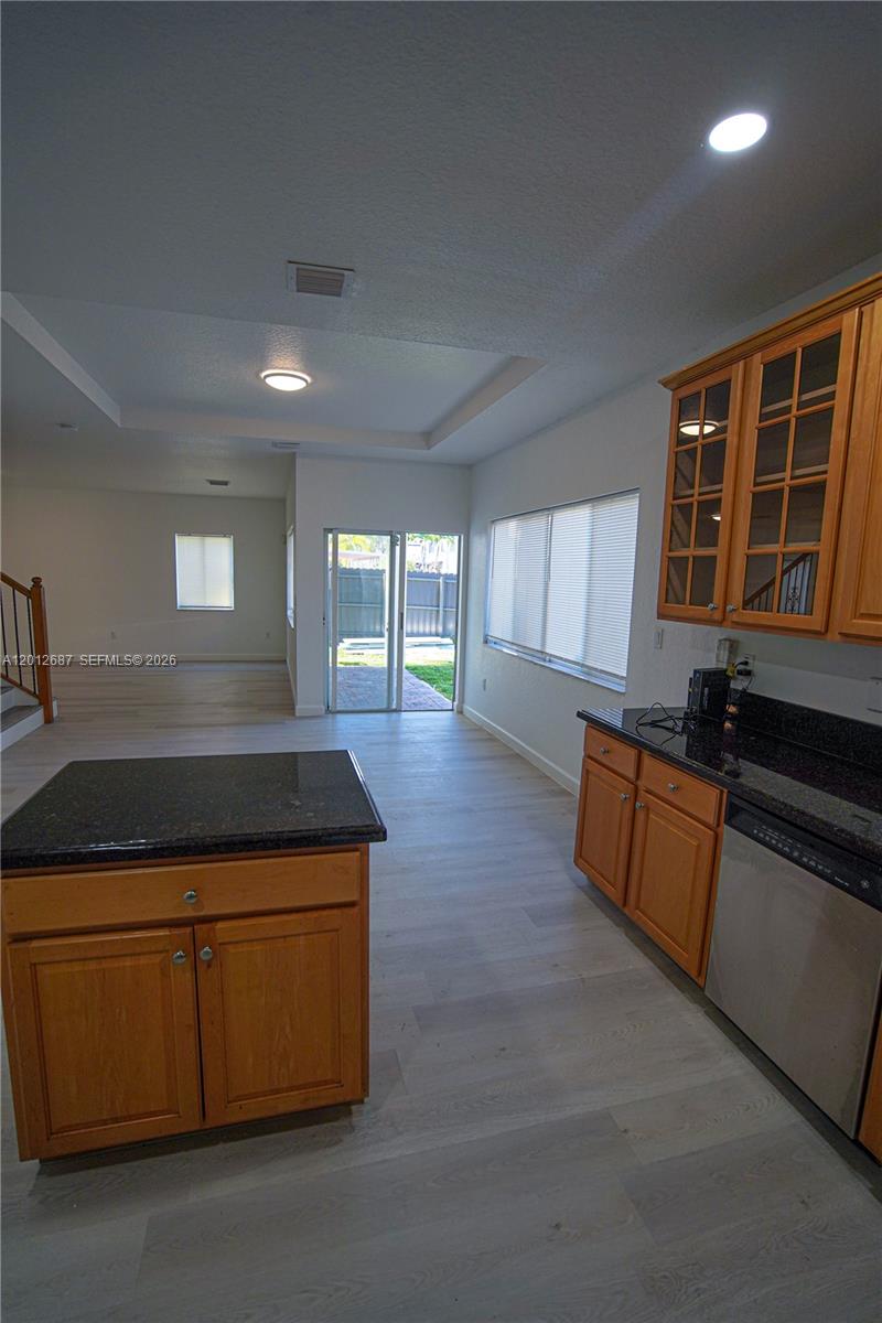 1751 Southwest 154th Path Miami, FL 33185 - Photo 8 of 41 a kitchen with wooden cabinets and center island