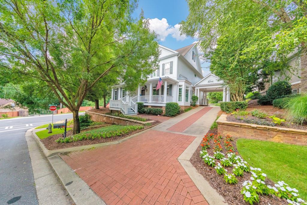 3901 Hazelhurst Drive Northeast Marietta, GA 30066 - Photo 1 of 79 a front view of a house with a garden and trees