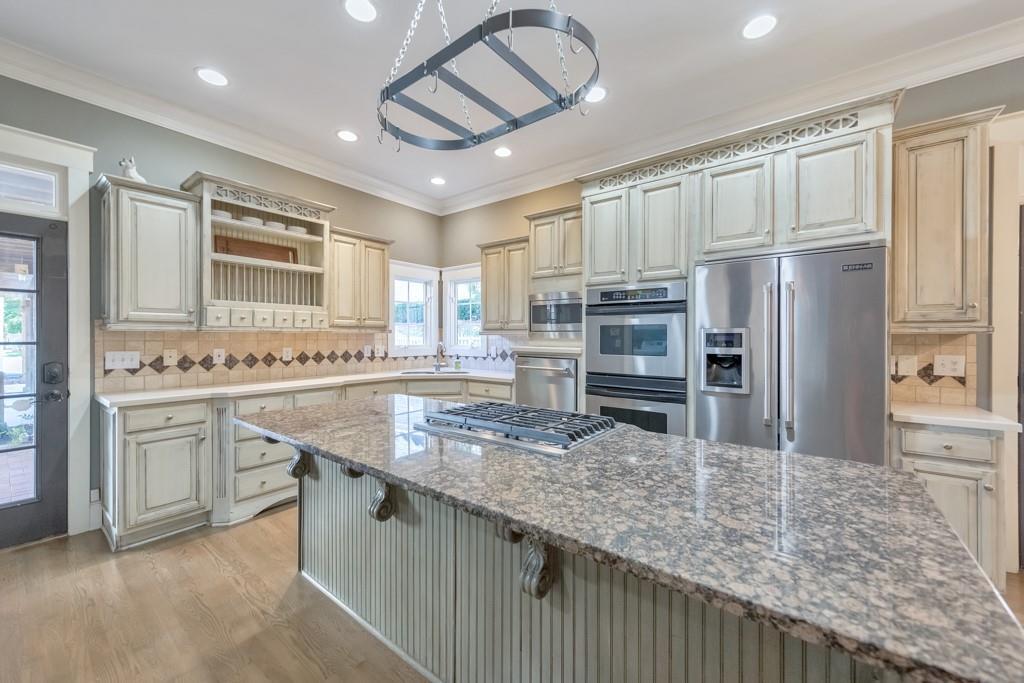 3901 Hazelhurst Drive Northeast Marietta, GA 30066 - Photo 24 of 79 a kitchen with stainless steel appliances granite countertop a sink stove and refrigerator