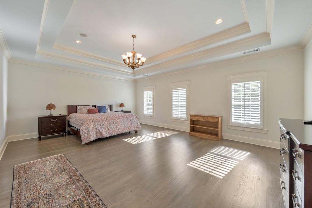 3901 Hazelhurst Drive Northeast Marietta, GA 30066 - Photo 28 of 79 a spacious bedroom with a bed and a table in it with chair