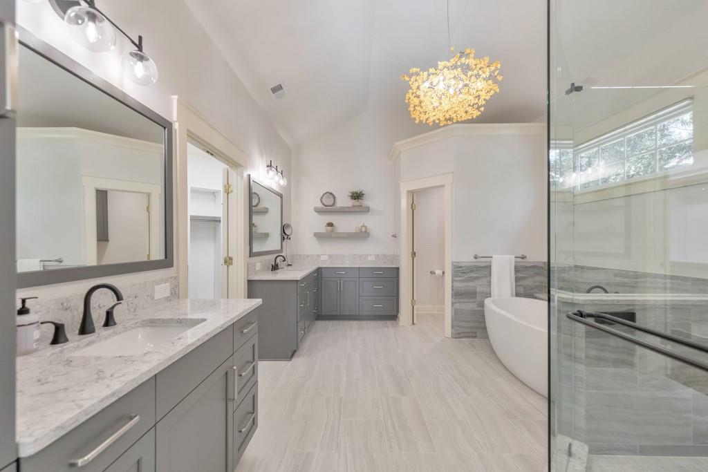 3901 Hazelhurst Drive Northeast Marietta, GA 30066 - Photo 30 of 79 a large bathroom with a granite countertop double vanity sink a mirror and a bathtub