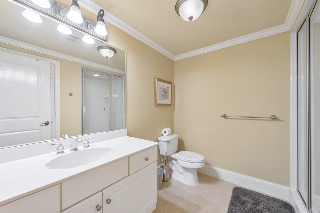 3901 Hazelhurst Drive Northeast Marietta, GA 30066 - Photo 47 of 79 a bathroom with a sink a toilet a light fixture and a mirror