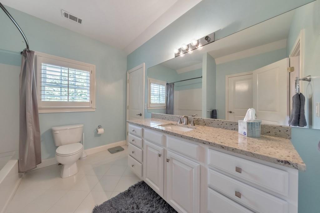3901 Hazelhurst Drive Northeast Marietta, GA 30066 - Photo 62 of 79 a bathroom with a granite countertop sink mirror vanity and toilet