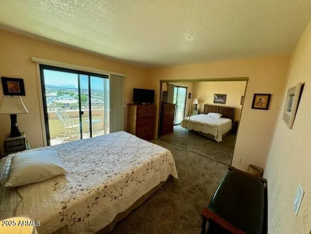 a bedroom with a bed and a large window