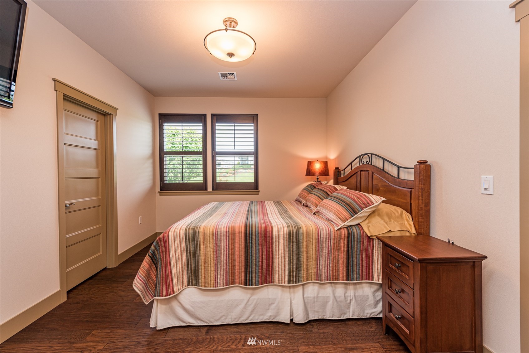100 Ridgecrest Court Sequim, WA 98382 - Photo 26 of 40 a bedroom with a bed and wooden floor
