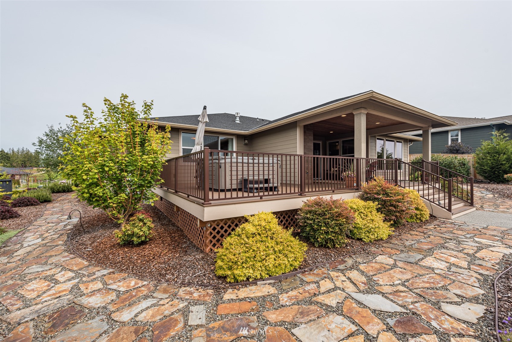 100 Ridgecrest Court Sequim, WA 98382 - Photo 36 of 40 a view of a house with wooden deck and furniture