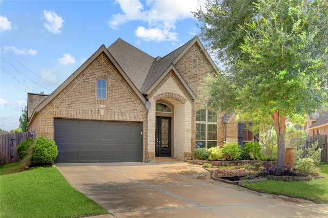 a front view of a house with a garden and plants