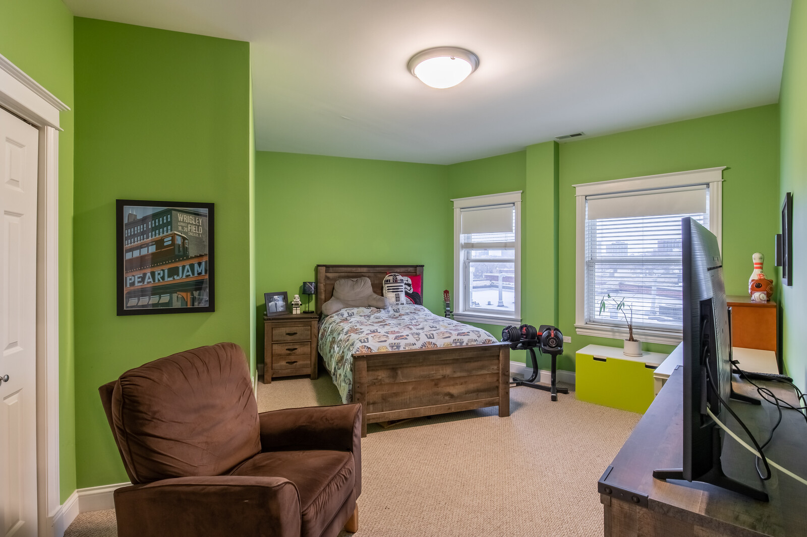 3755 North Racine Avenue, Unit 4E Chicago, IL 60613 - Photo 14 of 29 a bedroom with furniture and a flat screen tv