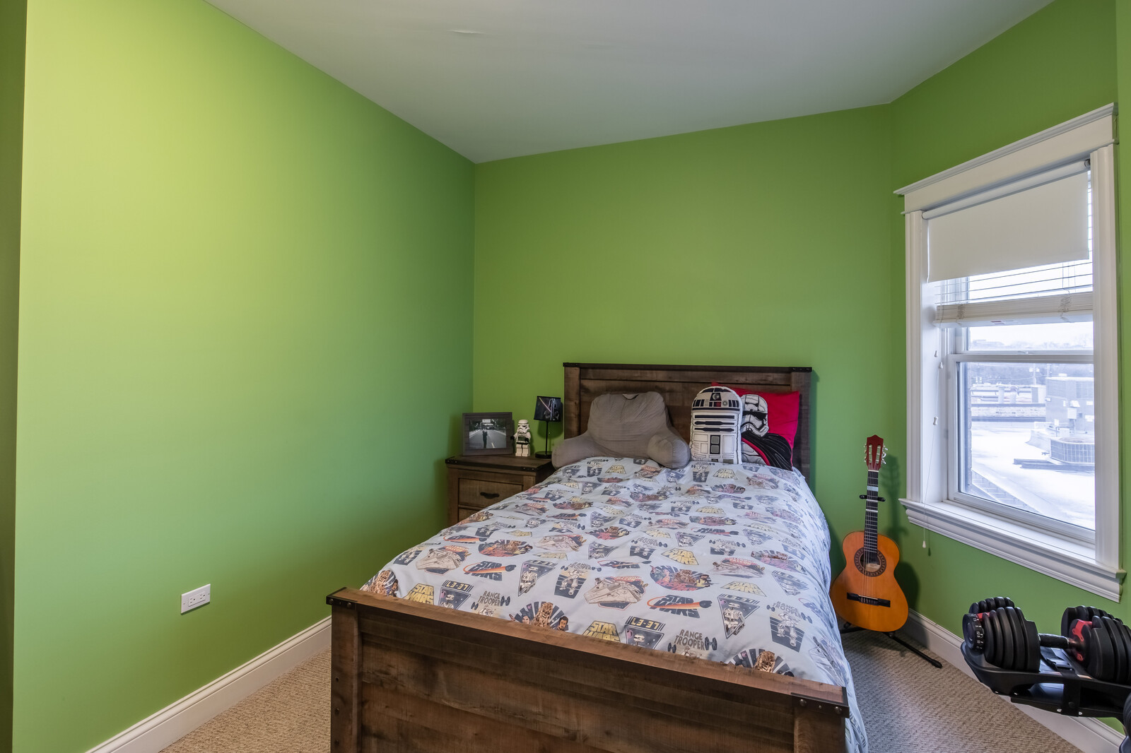 3755 North Racine Avenue, Unit 4E Chicago, IL 60613 - Photo 15 of 29 a bed sitting in a bedroom next to a window