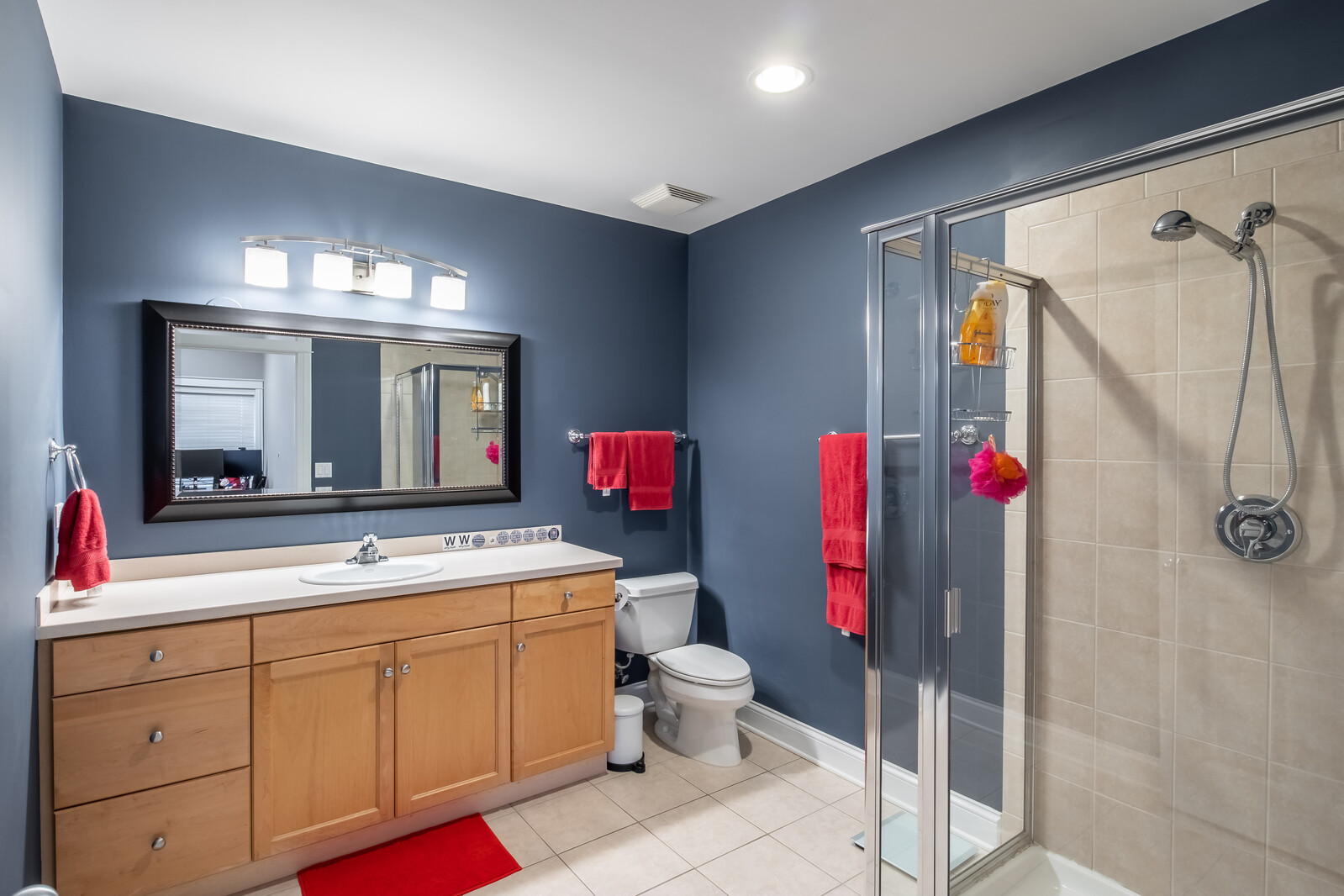 3755 North Racine Avenue, Unit 4E Chicago, IL 60613 - Photo 20 of 29 a bathroom with a sink vanity mirror and toilet