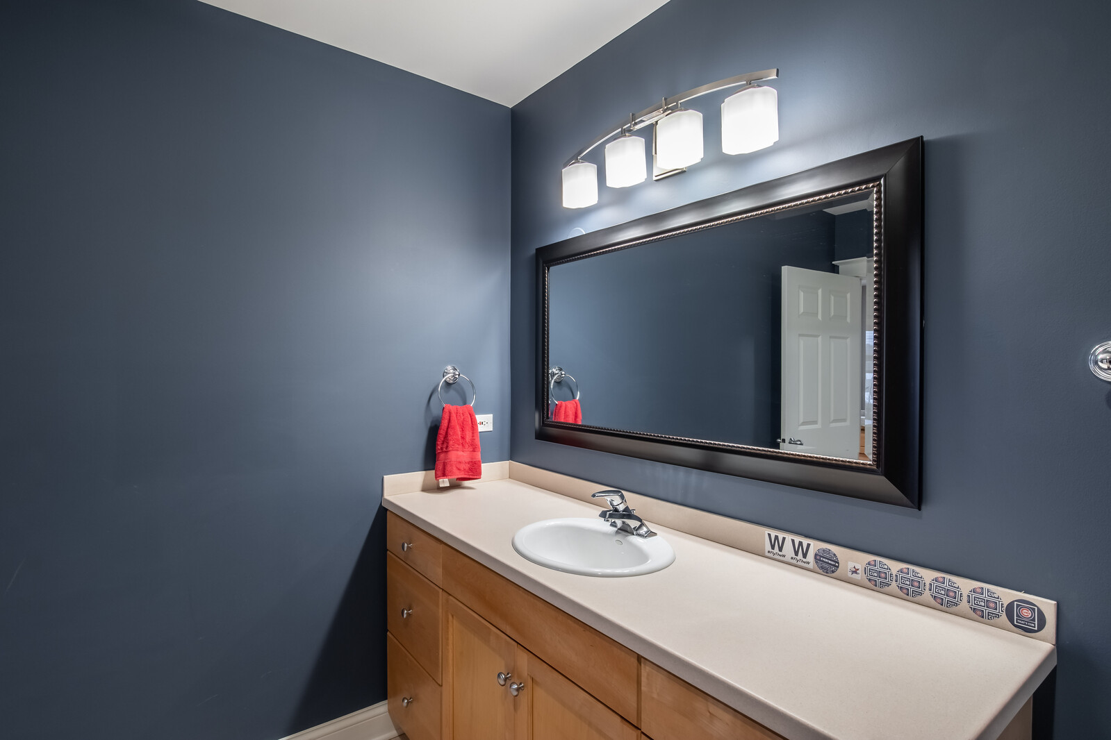 3755 North Racine Avenue, Unit 4E Chicago, IL 60613 - Photo 21 of 29 a bathroom with a sink vanity and a mirror