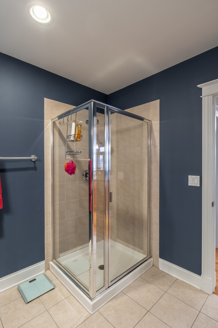 3755 North Racine Avenue, Unit 4E Chicago, IL 60613 - Photo 22 of 29 a bathroom with a shower and a sink