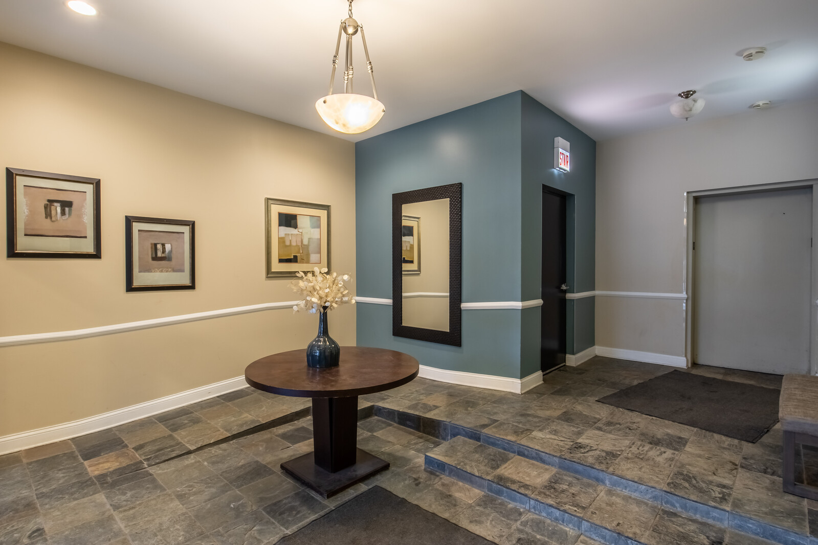 3755 North Racine Avenue, Unit 4E Chicago, IL 60613 - Photo 28 of 29 a living room with a couch and a chandelier