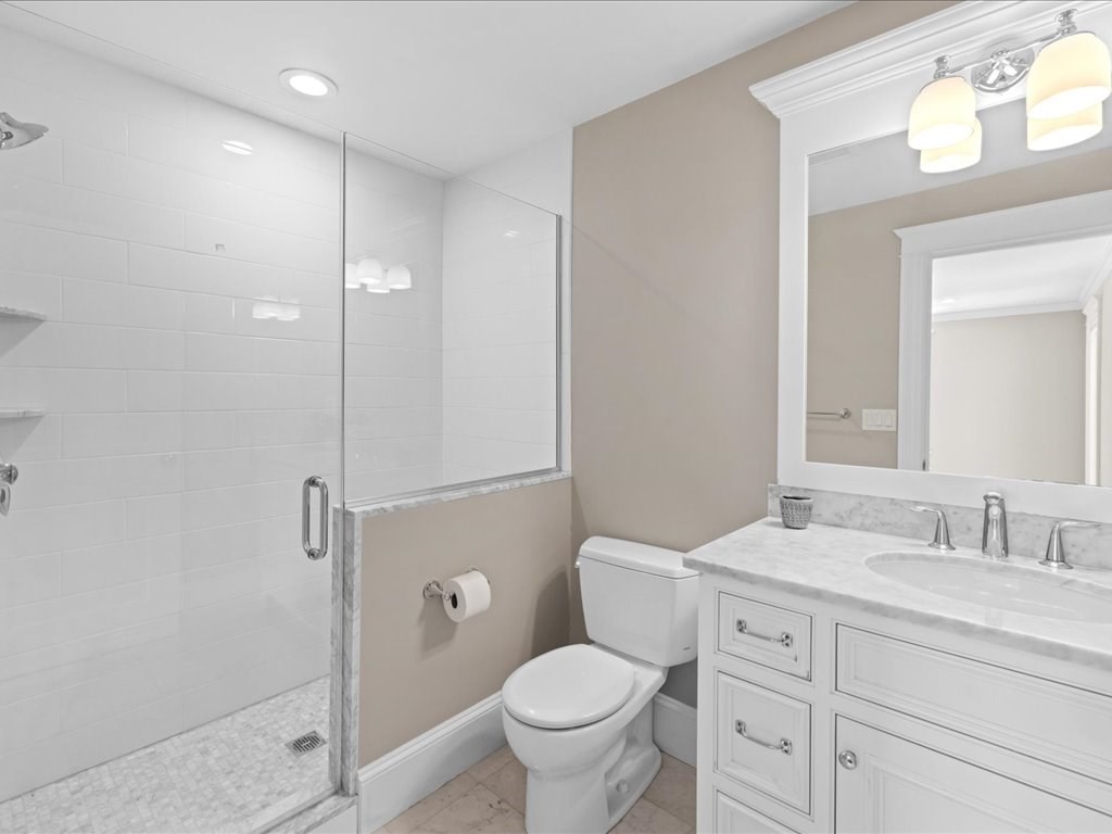 241 Bristol Road Wellesley, MA 02481 - Photo 22 of 42 a bathroom with a granite countertop toilet a sink and a mirror