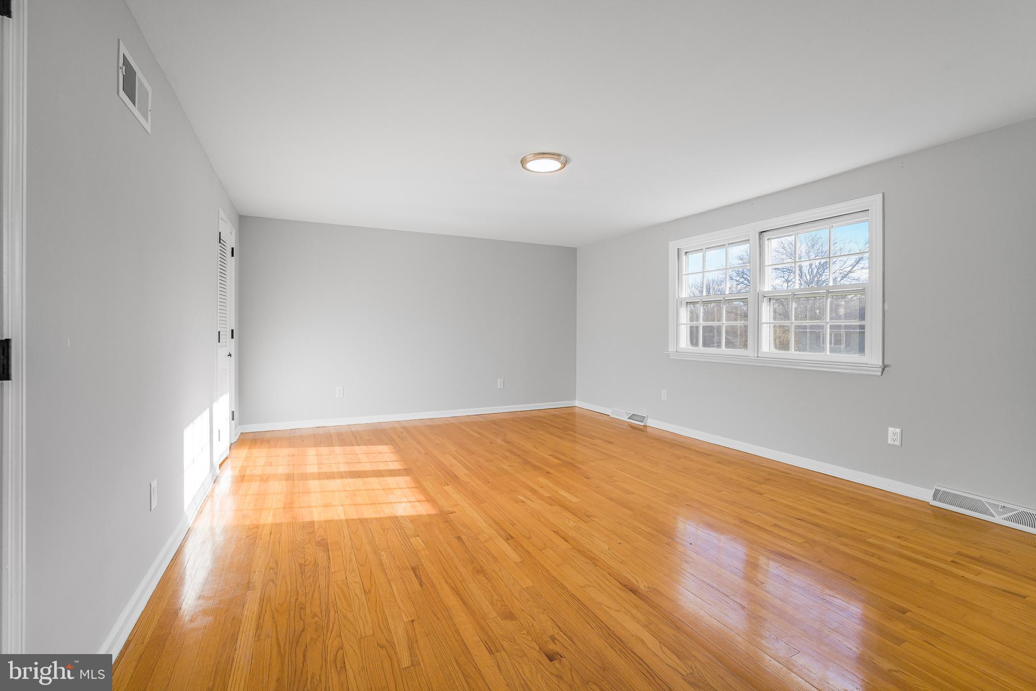 2205 Dorval Road Wilmington, DE 19810 - Photo 15 of 45 a view of an empty room with wooden floor and a window