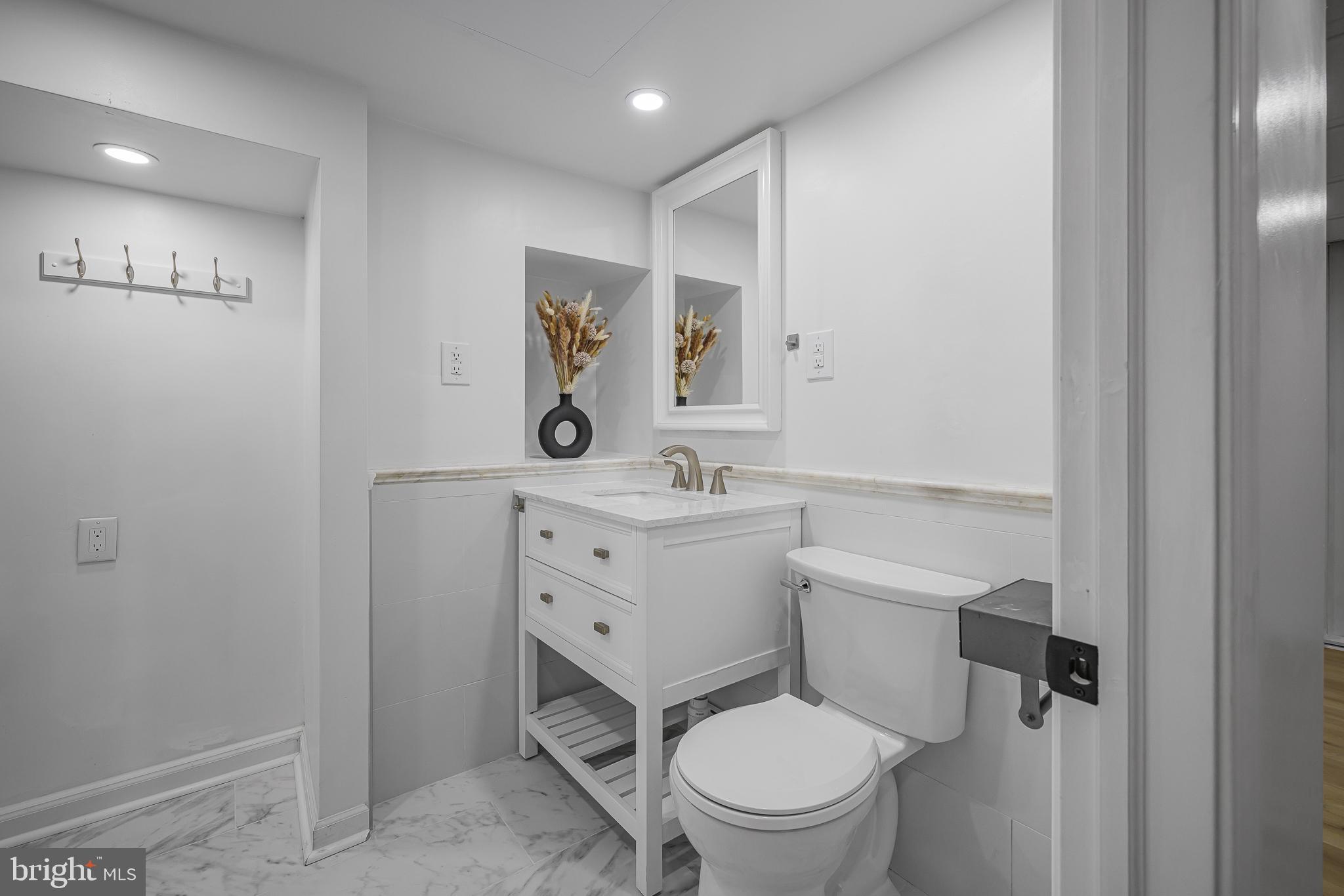 2205 Dorval Road Wilmington, DE 19810 - Photo 16 of 45 a bathroom with a toilet sink vanity and mirror