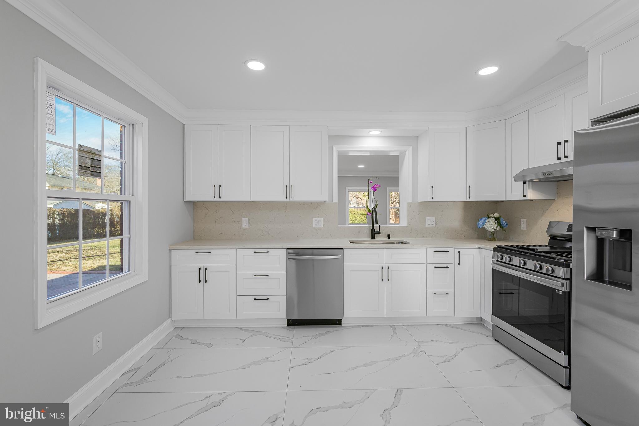 2205 Dorval Road Wilmington, DE 19810 - Photo 19 of 45 a kitchen with cabinets appliances and a window