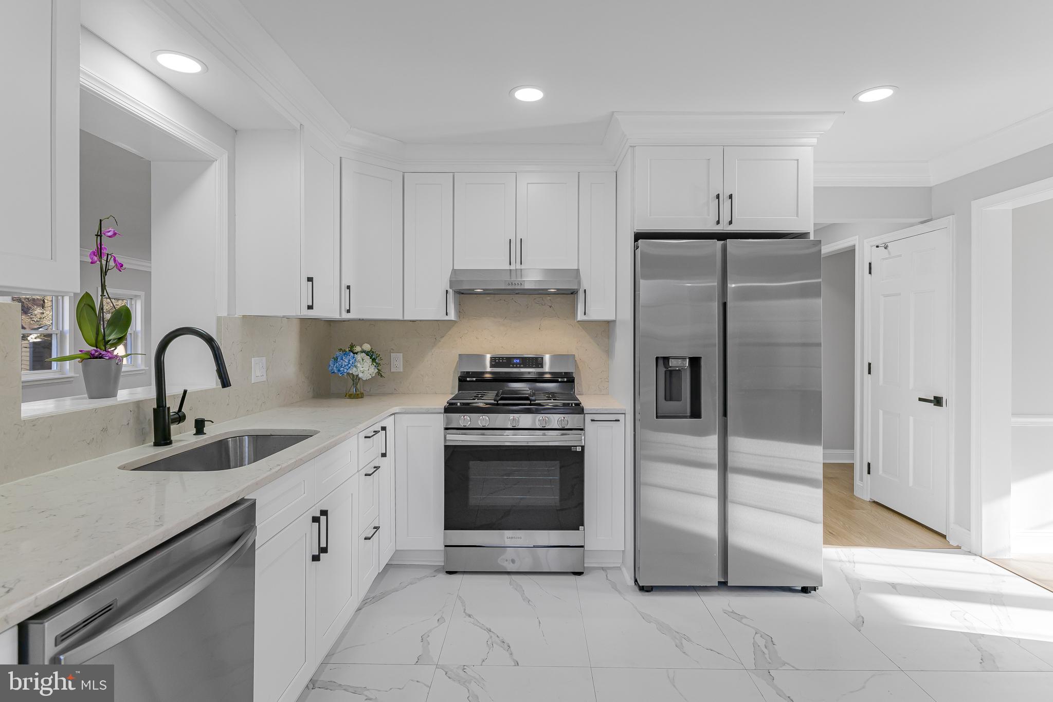 2205 Dorval Road Wilmington, DE 19810 - Photo 20 of 45 a kitchen with stainless steel appliances granite countertop a sink a stove a refrigerator and a oven with wooden floor