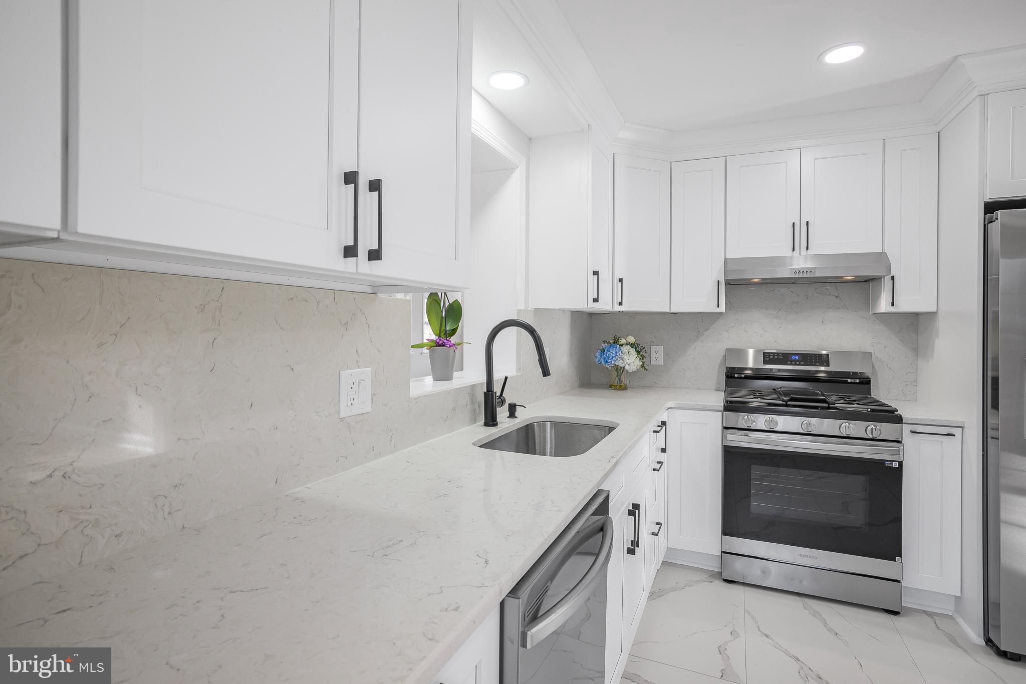 2205 Dorval Road Wilmington, DE 19810 - Photo 21 of 45 a kitchen with granite countertop a stove sink and cabinets