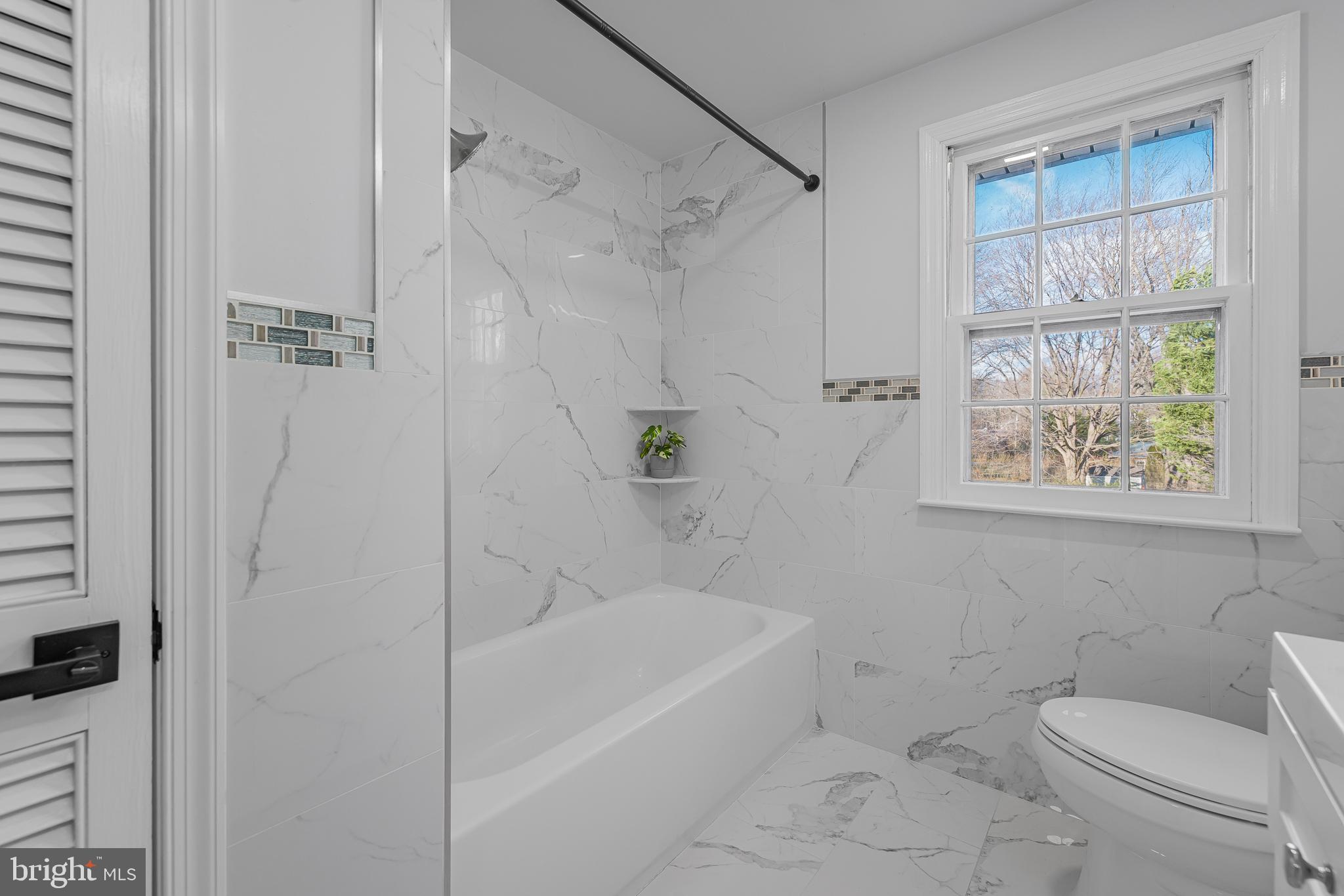 2205 Dorval Road Wilmington, DE 19810 - Photo 26 of 45 a bath room with a toilet a bath tub and a shower