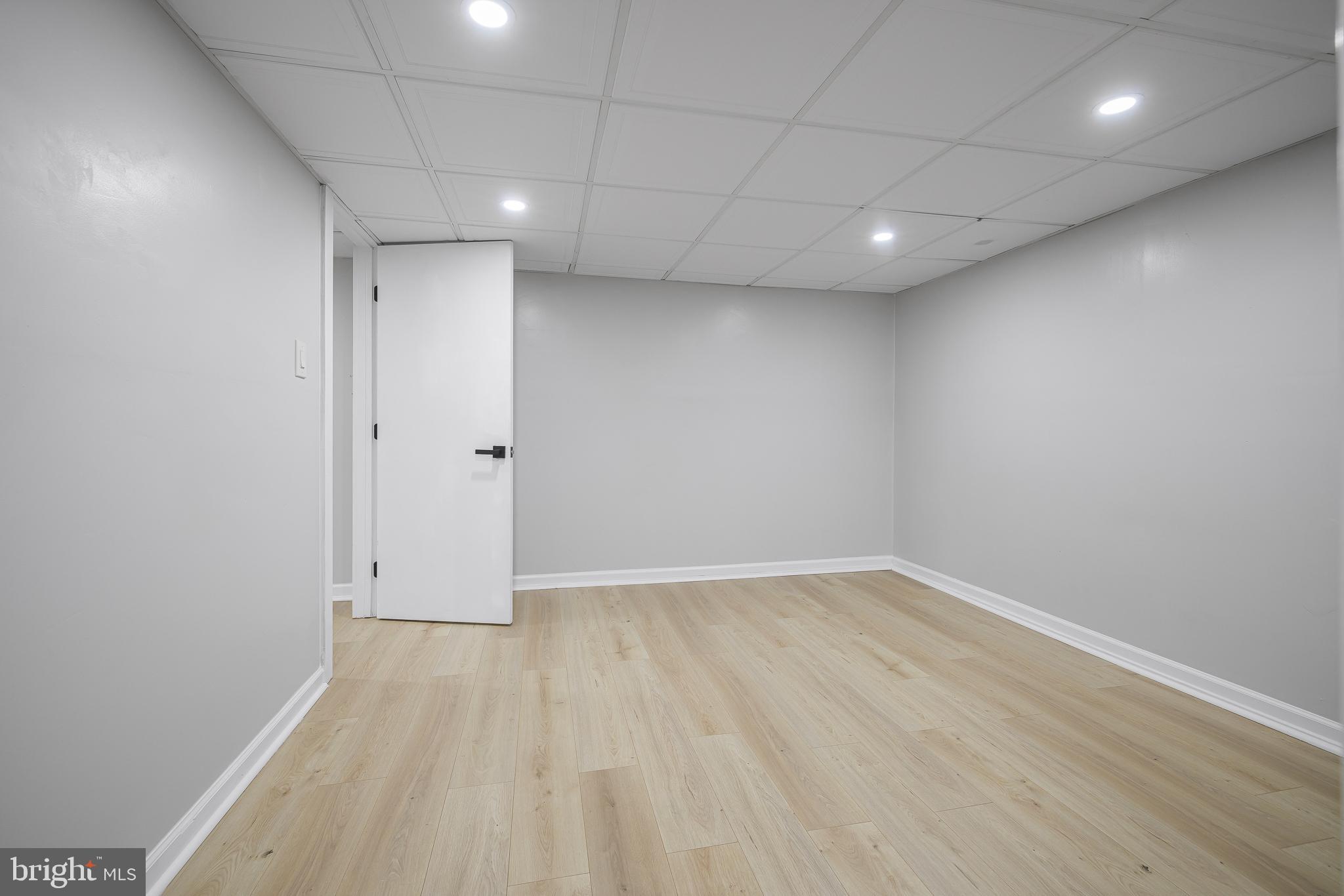 2205 Dorval Road Wilmington, DE 19810 - Photo 34 of 45 an empty room with wooden floor and white walls