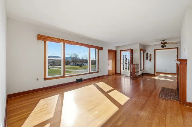 wooden floor in an empty room with a window