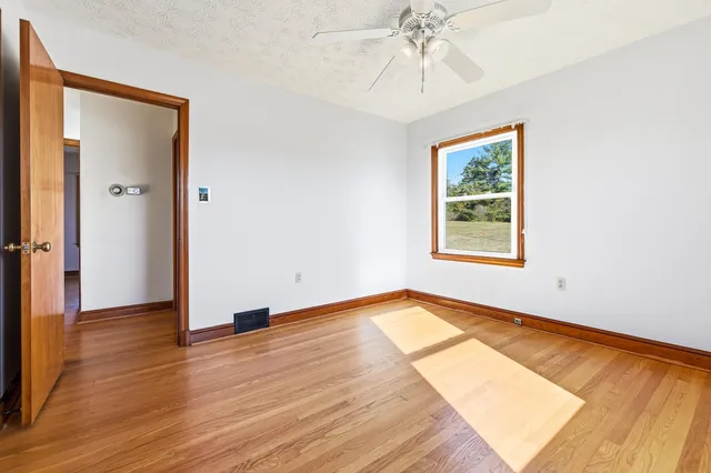 an empty room with wooden floor and closet