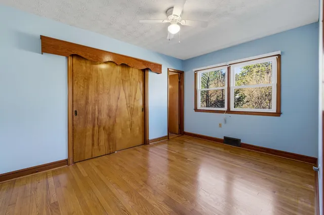a bed room with a bed and a large window