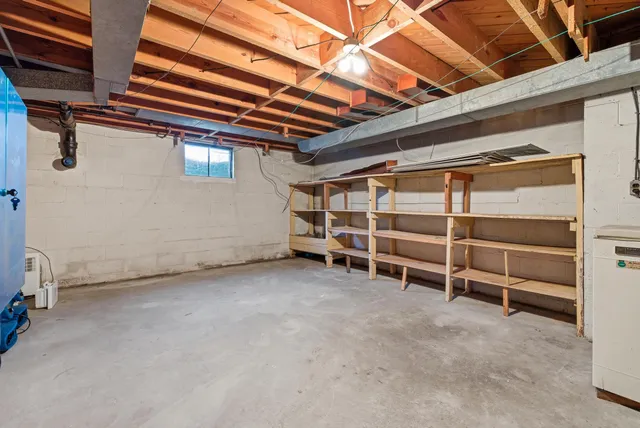 a view of a big house with a big yard and large trees
