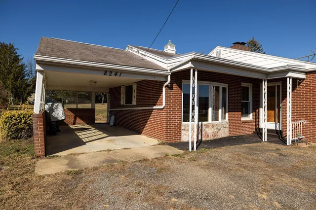a view of a yard with a house in the background