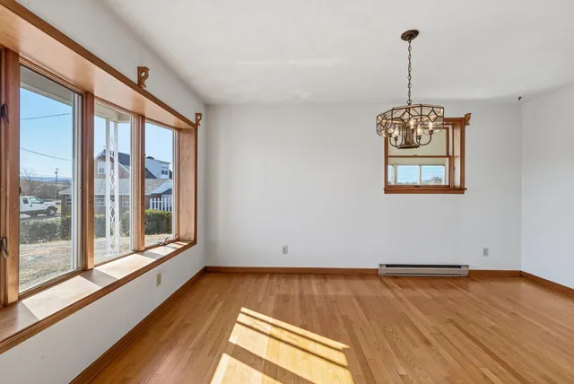 a view of a room with wooden floor and flat screen tv