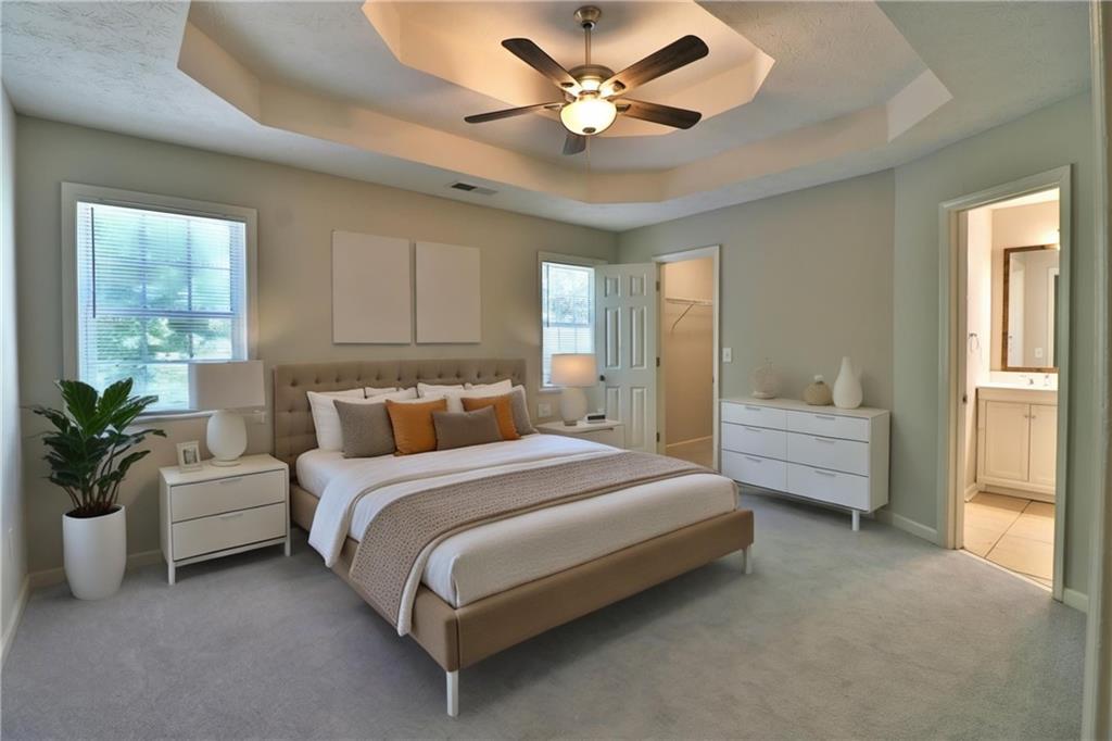 353 Fall View Court Winder, GA 30680 - Photo 37 of 61 a spacious bedroom with a bed and ceiling fan