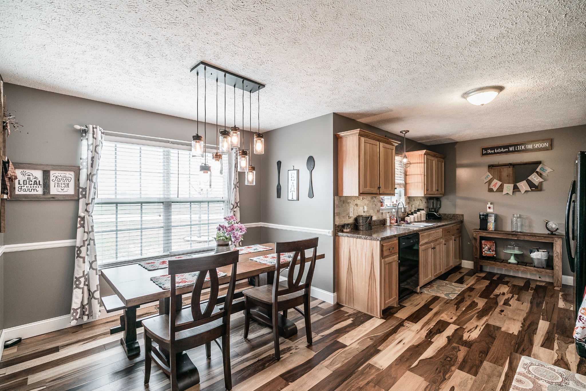 612 Denning Ford Road Portland, TN 37148 - Photo 5 of 26 a kitchen with stainless steel appliances a dining table chairs and wooden floor