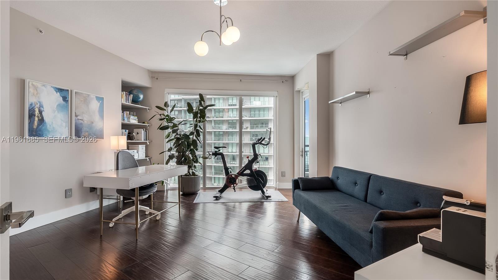 60 Southwest 13th Street, Unit 4200 Miami, FL 33130 - Photo 21 of 52 a living room with fireplace furniture and a wooden floor