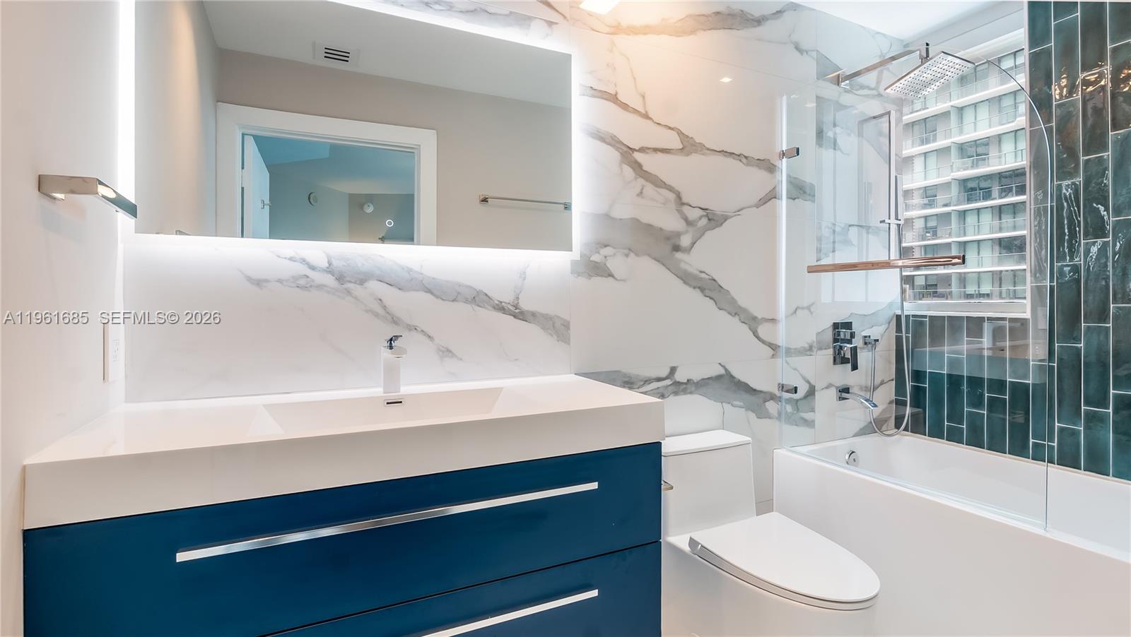 60 Southwest 13th Street, Unit 4200 Miami, FL 33130 - Photo 27 of 52 a bathroom with a sink a toilet and bathtub