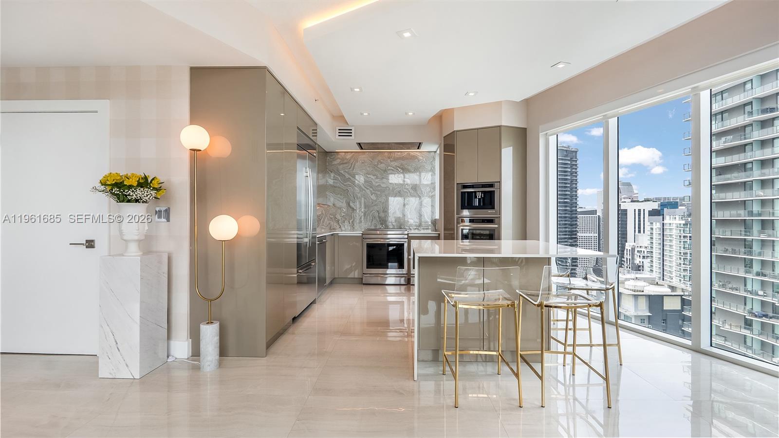60 Southwest 13th Street, Unit 4200 Miami, FL 33130 - Photo 5 of 52 a view of a hallway with dining area and chandelier