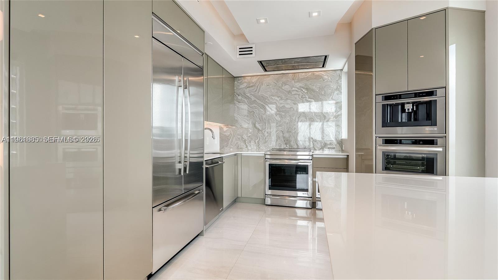 60 Southwest 13th Street, Unit 4200 Miami, FL 33130 - Photo 6 of 52 a view of a kitchen with a sink and dishwasher a refrigerator with wooden floor