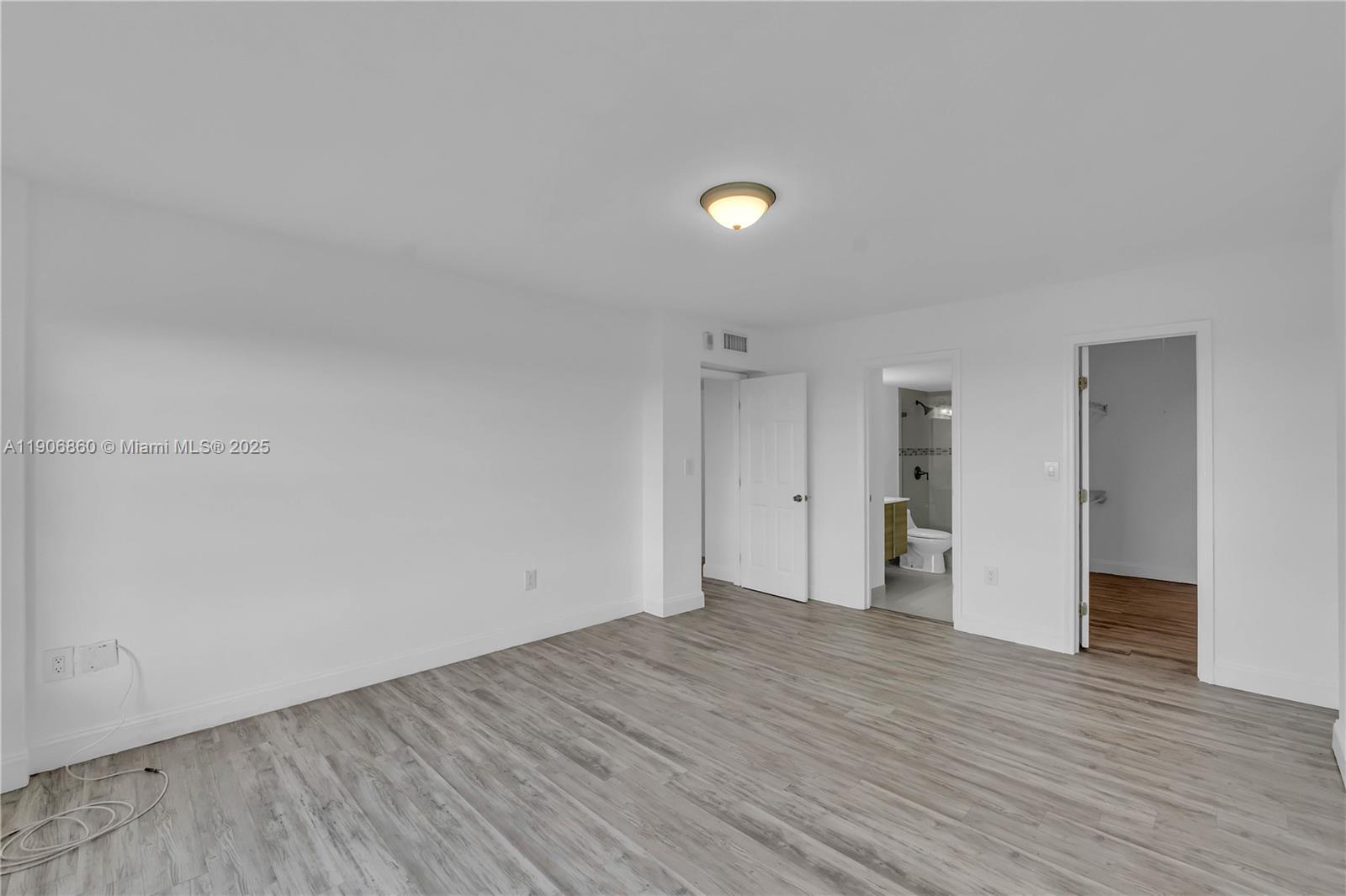 4164 Inverrary Drive, Unit 801 Lauderhill, FL 33319 - Photo 13 of 20 a view of an empty room with wooden floor and closet