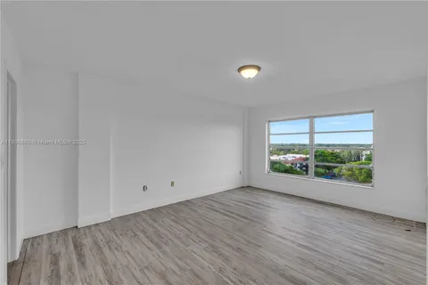 a view of room with window and wooden floor