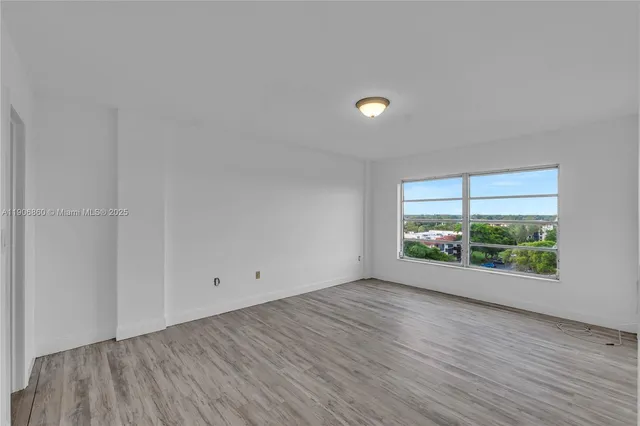 a view of room with window and wooden floor