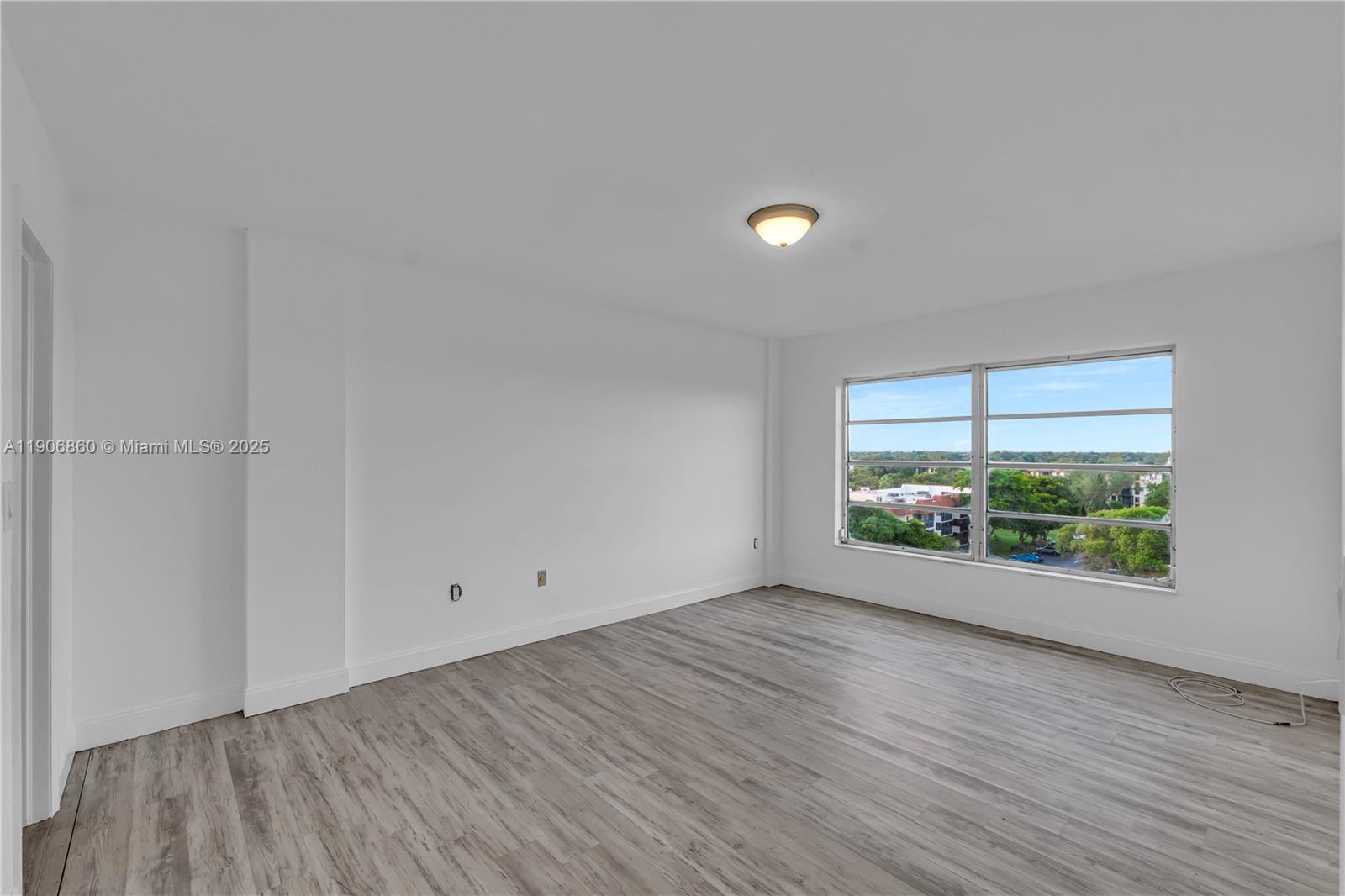 4164 Inverrary Drive, Unit 801 Lauderhill, FL 33319 - Photo 14 of 20 a view of room with window and wooden floor