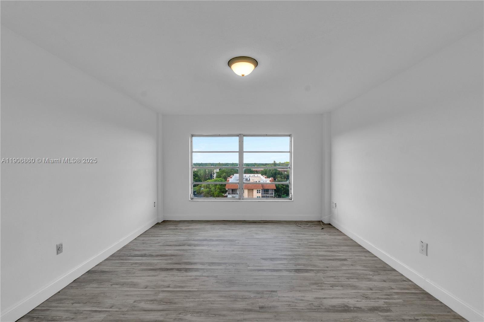 4164 Inverrary Drive, Unit 801 Lauderhill, FL 33319 - Photo 18 of 20 wooden floor in an empty room with a window