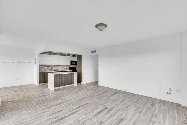 a kitchen with a refrigerator and white stove top oven
