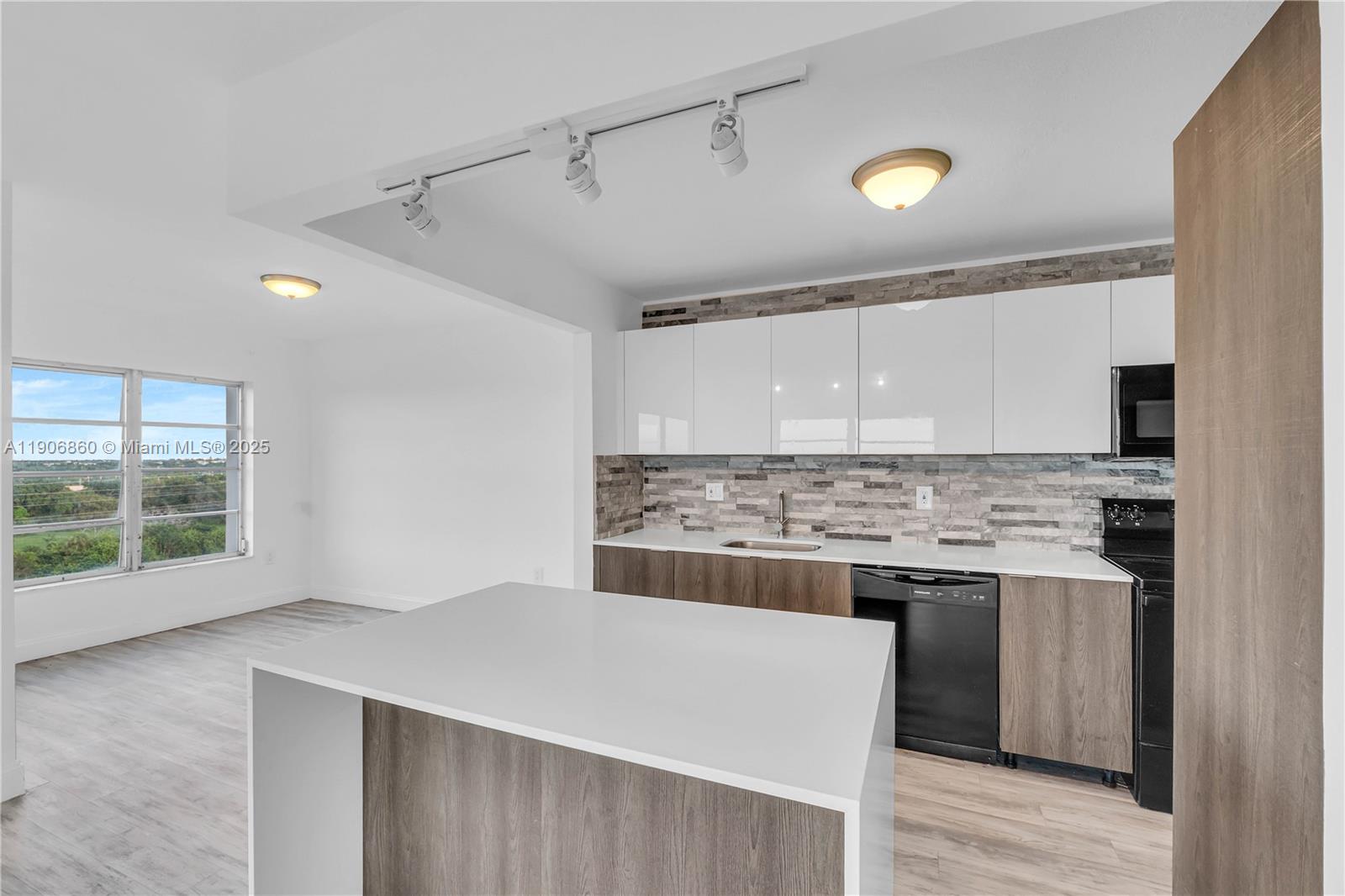 4164 Inverrary Drive, Unit 801 Lauderhill, FL 33319 - Photo 8 of 20 a kitchen with a stove and a sink