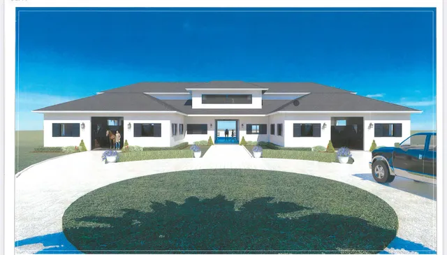 a front view of a house with a yard table and chairs