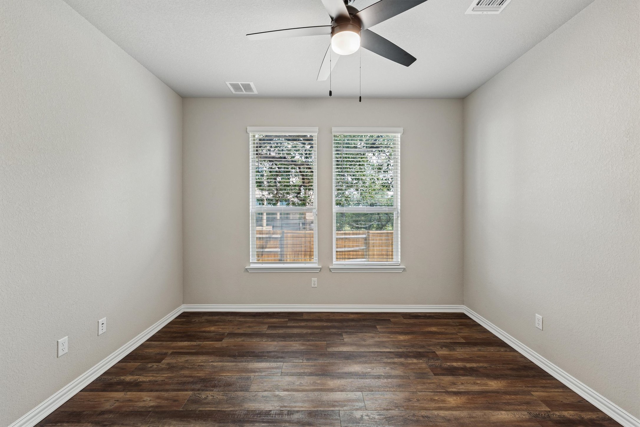 324 Autumn Oak Way Georgetown, TX 78628 - Photo 14 of 40 Room featuring wood-finish flooring, two windows with blinds, a ceiling fan with integrated lighting, and neutral wall tones