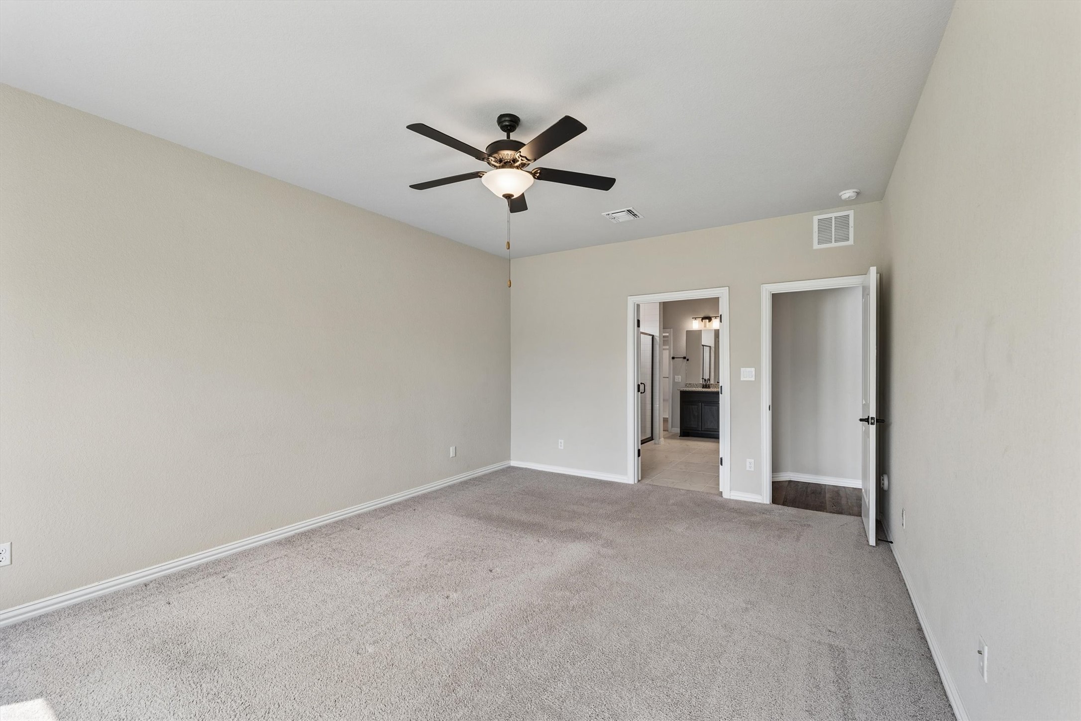 324 Autumn Oak Way Georgetown, TX 78628 - Photo 17 of 40 Spacious room featuring neutral carpeting, light-toned walls, and a ceiling fan with integrated lighting