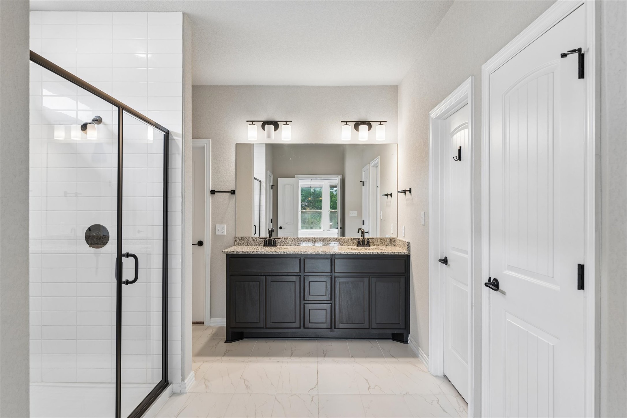 324 Autumn Oak Way Georgetown, TX 78628 - Photo 18 of 40 Bathroom featuring a double vanity with dark wood cabinetry, granite-style countertop, and dual sinks