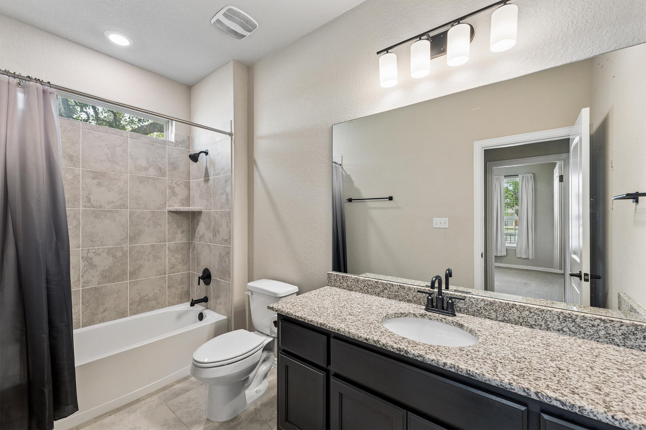 324 Autumn Oak Way Georgetown, TX 78628 - Photo 22 of 40 Full bathroom featuring a tub and shower combination with light-colored tile surround and built-in niche